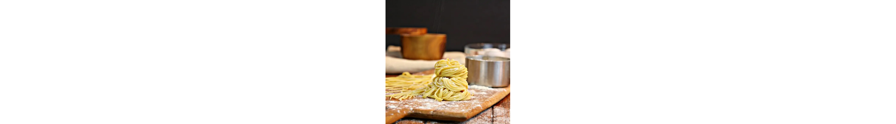 Pile of freshly-rolled pasta on a wood platter 